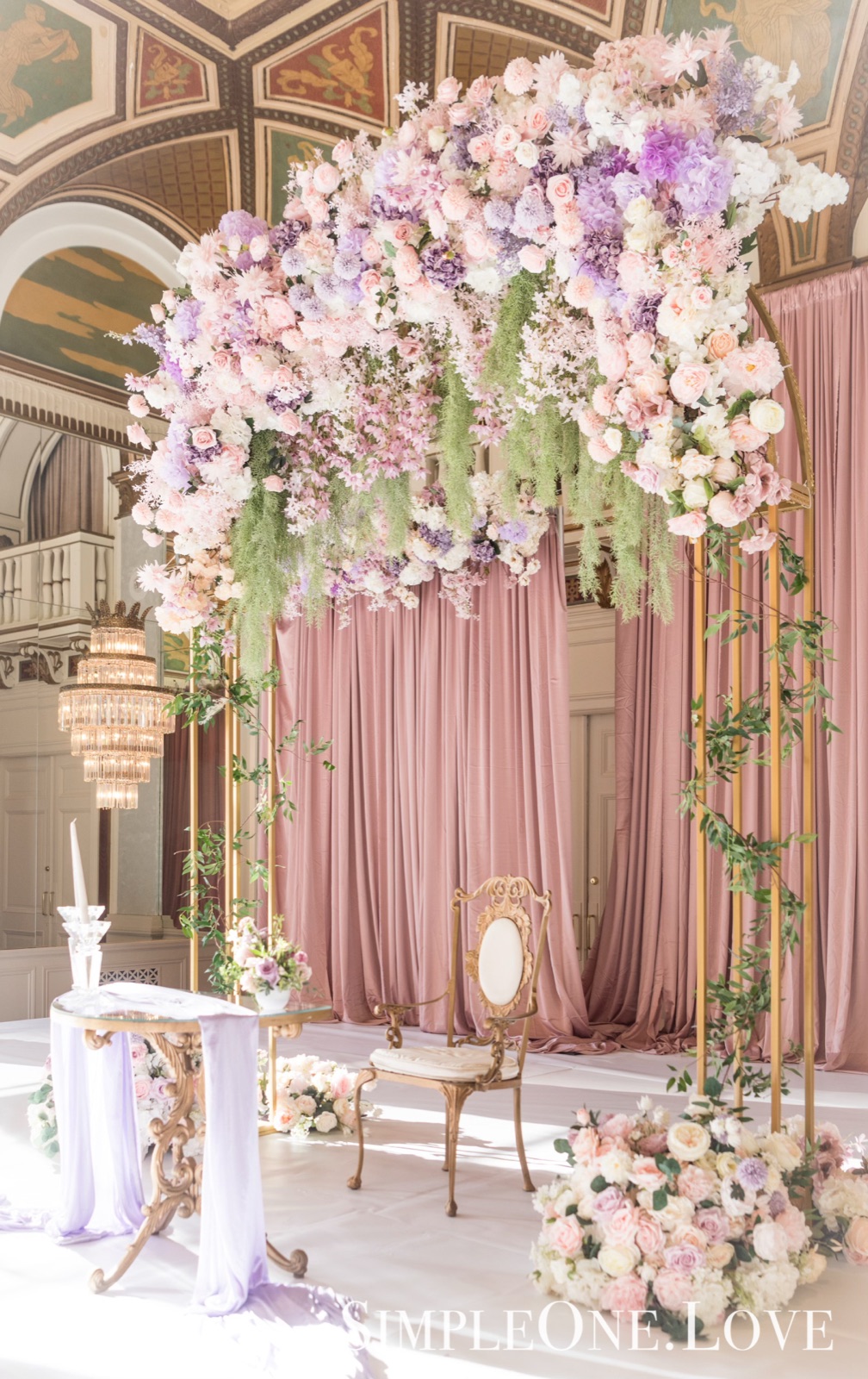 A welcome display of pink flowers and framed signs in the hotel foyer.