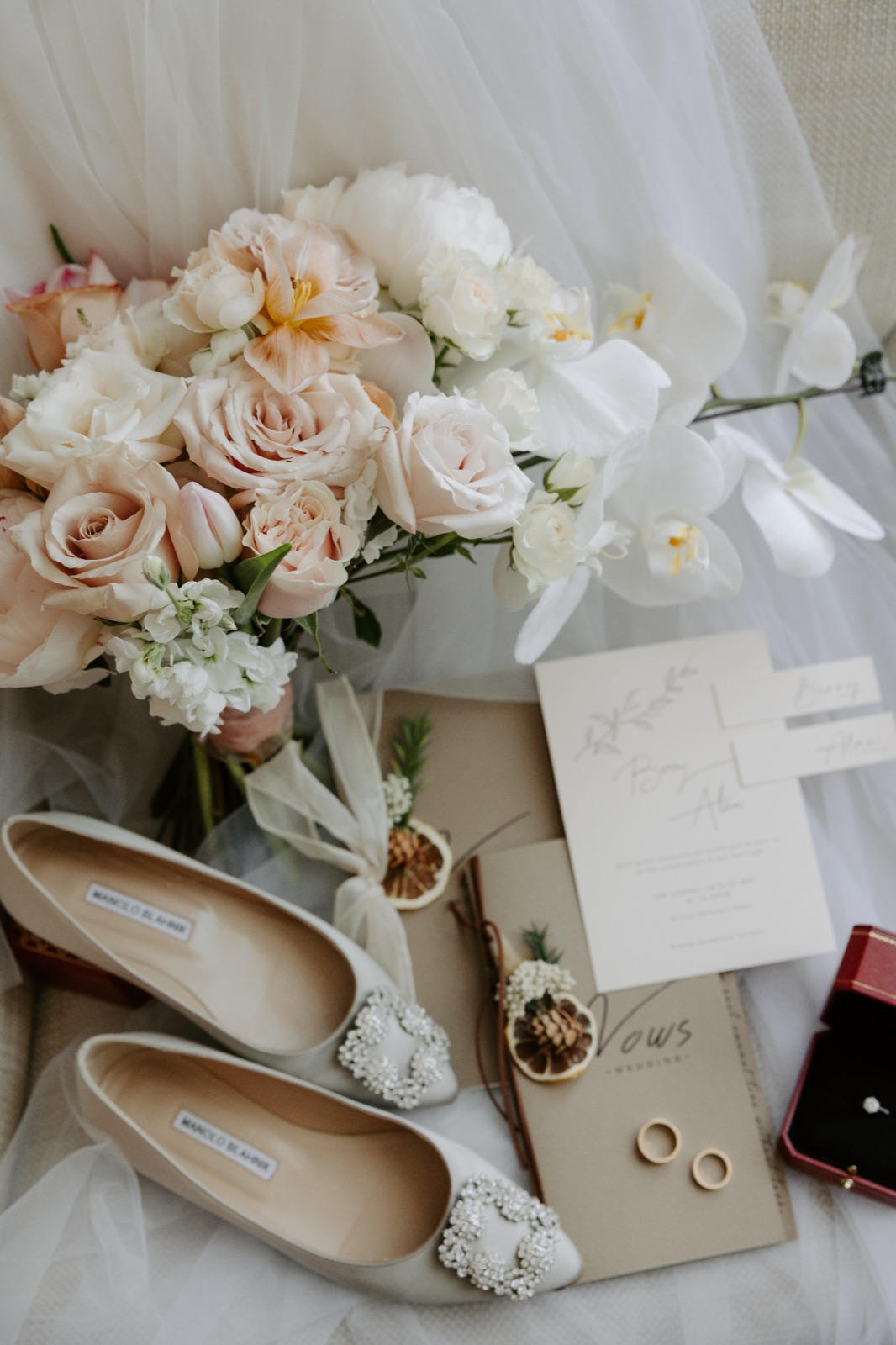 Invitations, shoes and flowers laid out before the day begins.