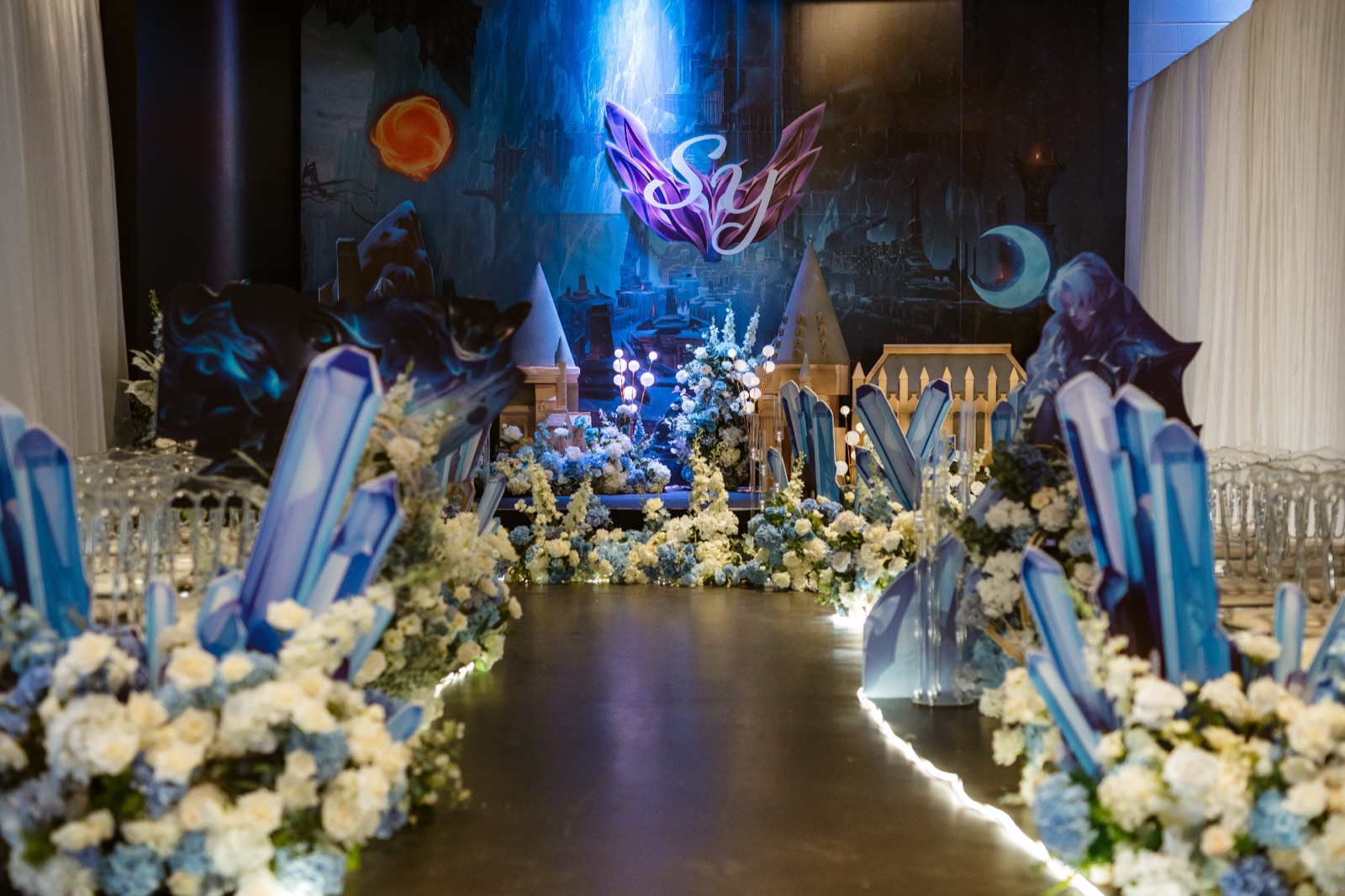 Blue light and white flowers over a reception set for the evening.